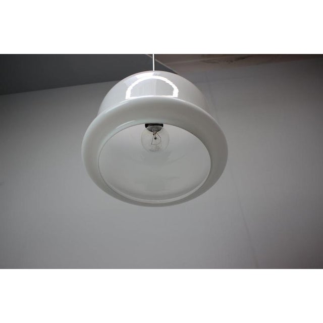 Striking vintage pendant lamp manufactured in Czechoslovakia around 1970. The sculptural shade is crafted from glossy...