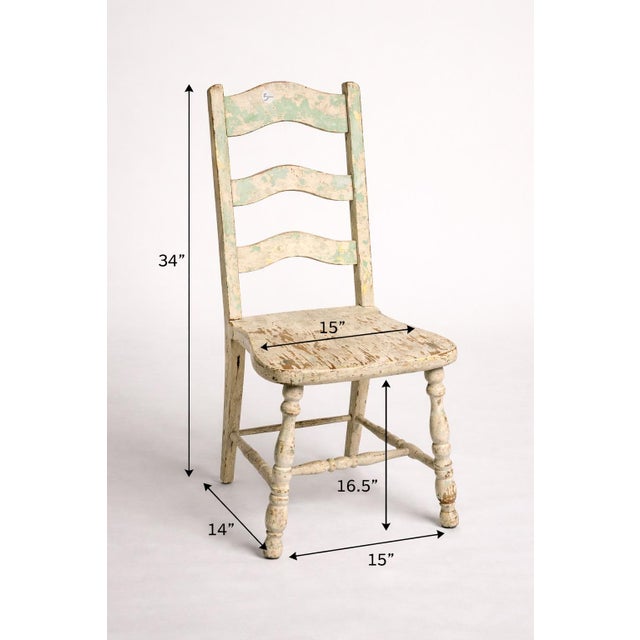 Charming antique American ladder-back chair with original layered paint and beautifully worn patina. Petite scale with...
