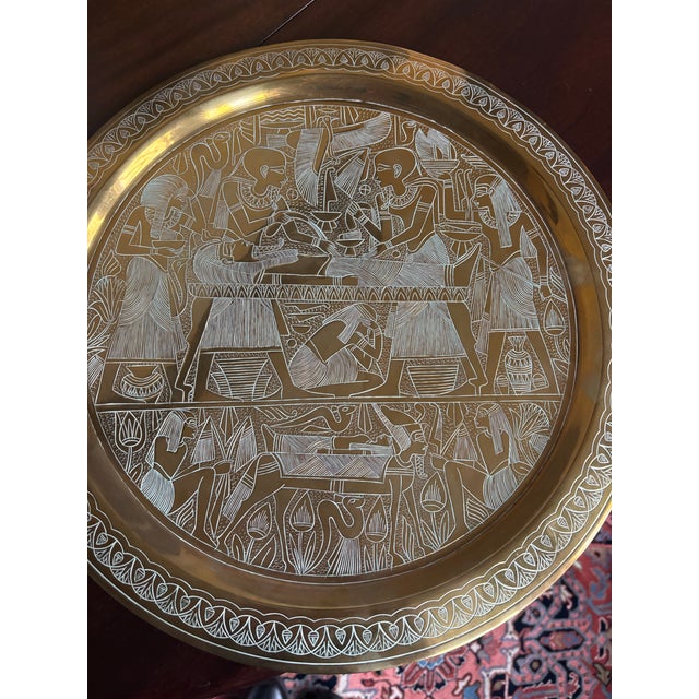 Pair of Large brass decorative plates from Egypt. Each plate depicts a different aspect of Ancient Egyptian life.