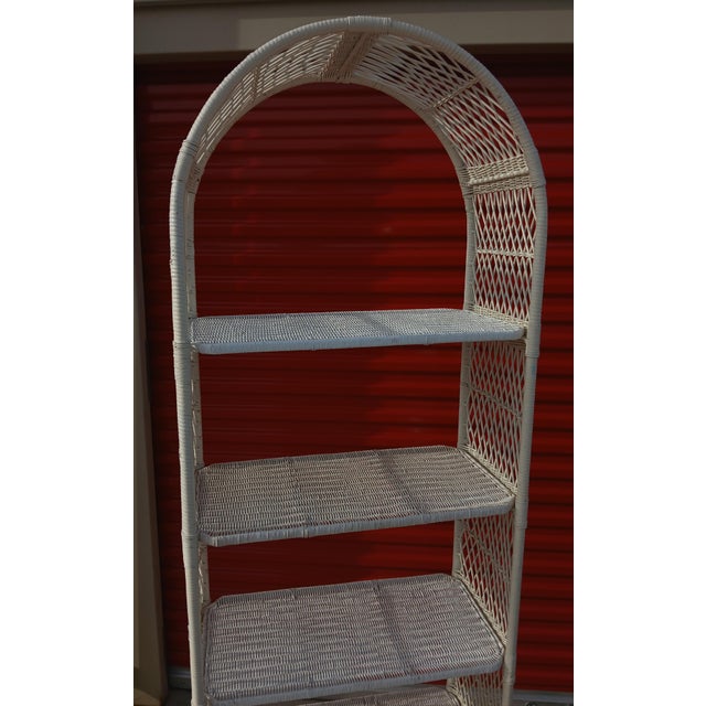 Bring a touch of retro coastal charm to your space with this vintage white rattan and wicker arched bookcase. Perfectly...