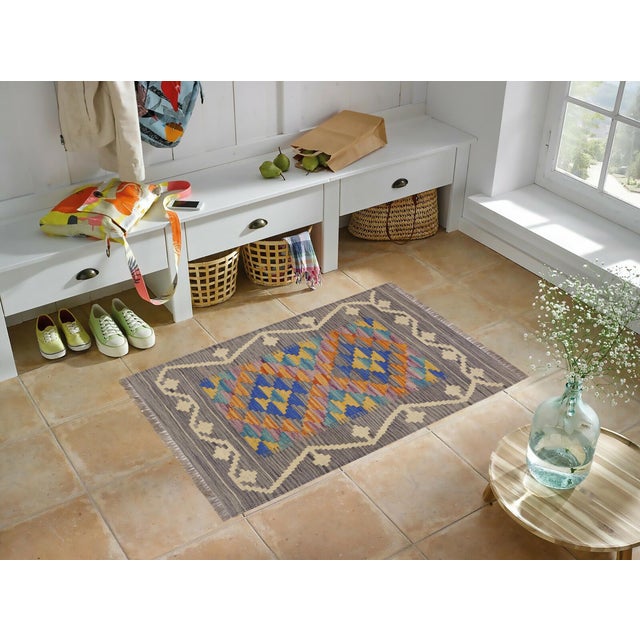 Elevate the elegance of your home with this stunning hand-woven tribal Kilim wool rug. Meticulously crafted on a loom by...