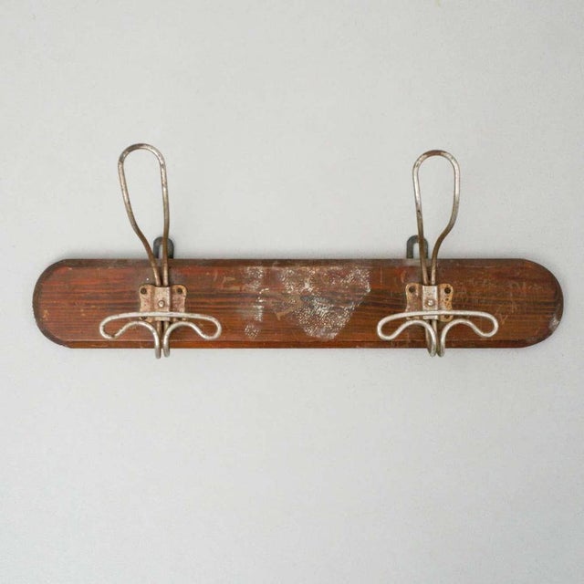Wood and metal coat rack, circa 1930. By unknown manufacturer. (France). In original condition, with wear consistent of...