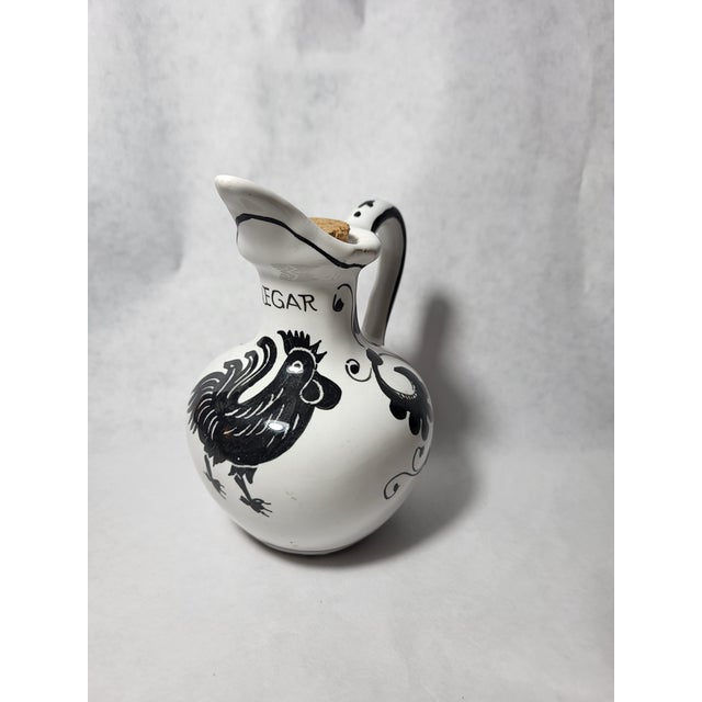 Offered here is an Italian vinegar jar. Handpainted white and black design on all sides. Marked Italy.