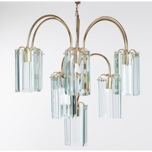 Waterfall form brass chandelier with rectangular beveled glass prisms, circa 1980.
