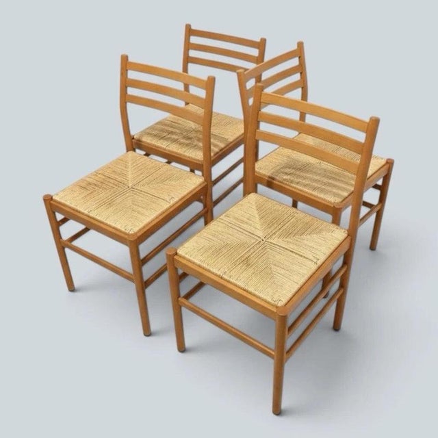 A beautifully crafted set of four mid-century Italian dining chairs combining solid beech ladderback frames with handwoven...