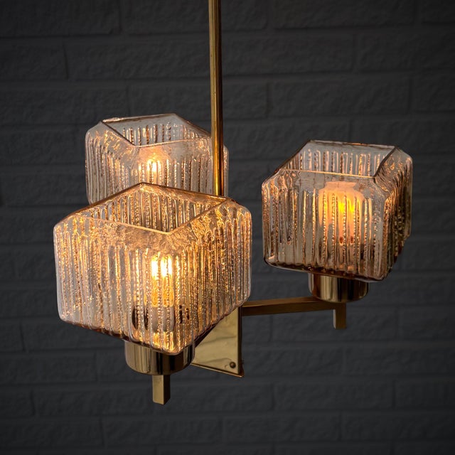 A compact mid-century chandelier produced by an unidentified Swedish manufacturer in the 1960s. Defined by its clean...