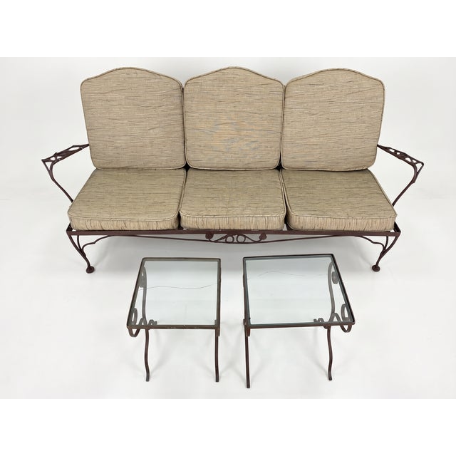 A rare and complete vintage Woodard wrought iron garden suite in the ivy leaf and vine pattern, comprising a three-seat...