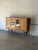 This grand piece features an expansive silhouette accented by carved details and arched leaded glass doors. The robust...