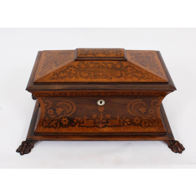 This is an exquisite antique George IV Gonçalo Alves and amboyna marquetry inlaid tea caddy, circa 1825 in date. It is...