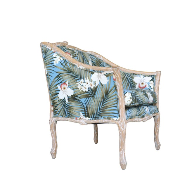 A generously proportioned bergère-style armchair with a sculptural branch-form carved wood frame and newly upholstered...