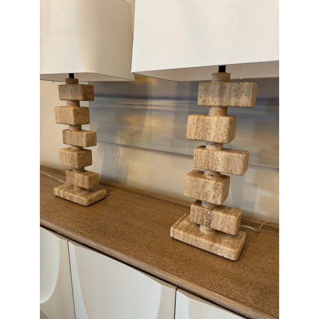 Playfully placed blocks of beige unfilled travertine stack up to make a beautiful lamp. The soft curves of the blocks are...