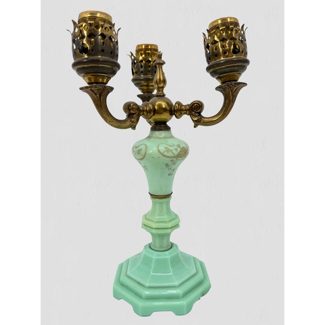Vintage table lamp with a three-light cluster, made of brass and jadeite. The lamp features a decorative etched base and...