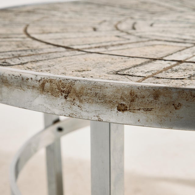 Steel coffee table with glazed stone top from the 1970s, designed by Edel Hegedal for L. Hjorth. The surface of the table...