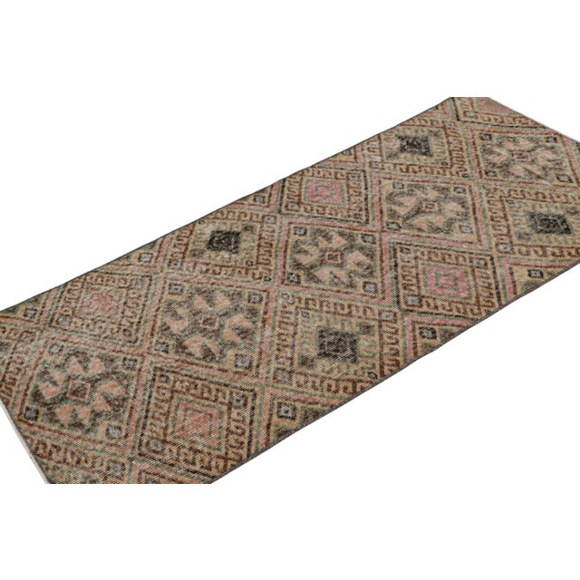 This vintage 3x6 rug, hand-knotted in wool, originating from Turkey, circa 1960-1970, features Zeki Müren’s mid-century...