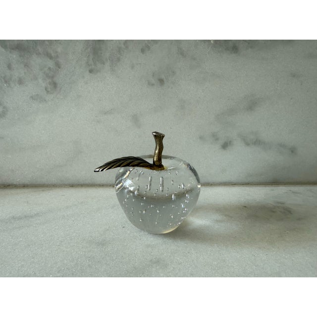 Vintage blown glass paper weight in the shape of an apple with a brass tone stem and leaf.