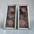 A charming pair of vintage neoclassical wall plaques featuring classical cherub medallions displayed against richly...