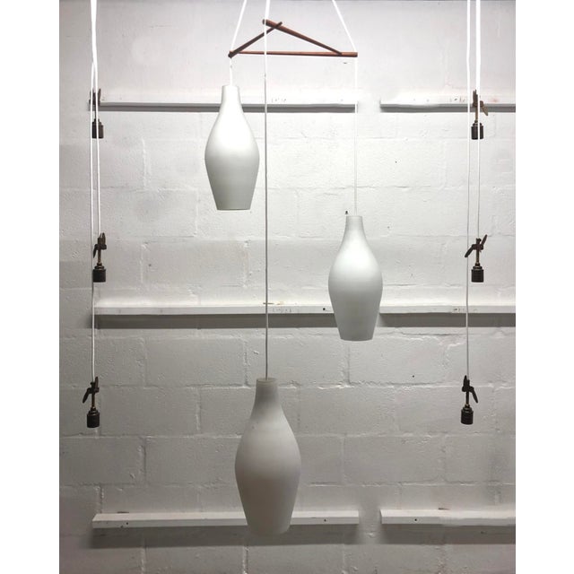 Mid-Century Modern Mid-Century Scandinavian Three-Drop Cascade Opaline Cased Glass Bowling Pin Lights in Teak, 1960s For Sale - Image 3 of 15