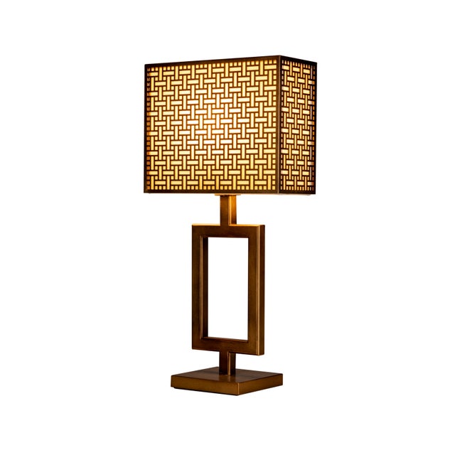 Polaris is a metal table lamp made in Italy, characterized by a slender, open structure. Resting on a brass base, the...