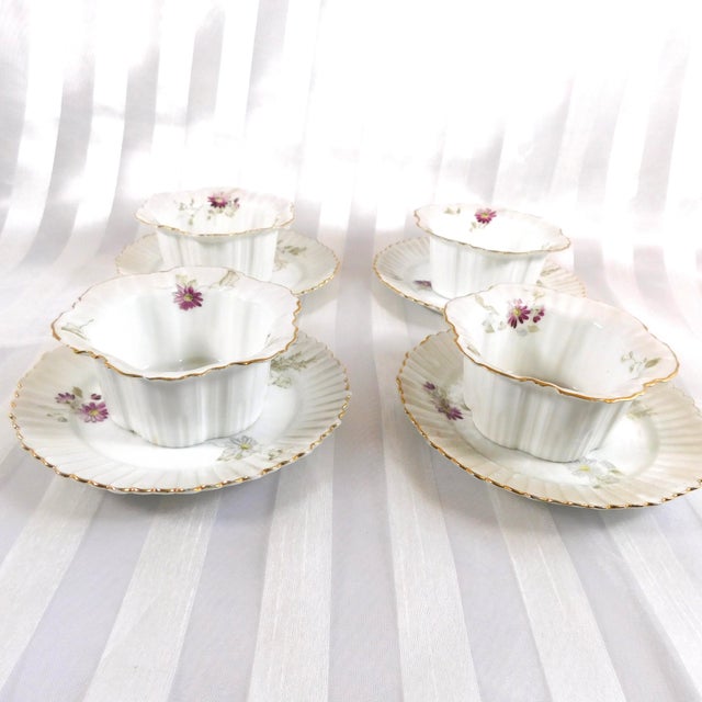 This is a a set of four hand painted or hand decorated Rosenthal ramekin dishes and underplates. They are thin shaped and...