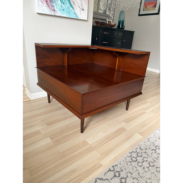 This is a beautiful mid century modern corner step table. This features an L-shaped design to fit into a corner, with a...