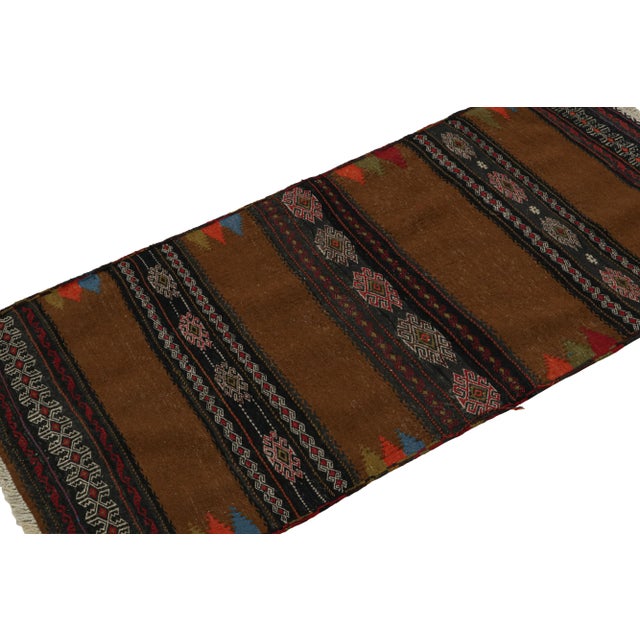 Handwoven in wool, this 2x5 vintage Afghan tribal kilim rug, circa 1950-1960, is an exquisite tribal addition to the Rug &...