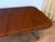 This is a classic traditional banded mahogany dining table by Leighton Hall. It features an understated field of cathedral...