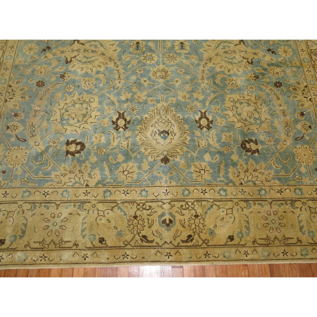 An early 20th-century room-size persian Tabriz rug. This piece is a true antique, one-of-a-kind rug that has been...