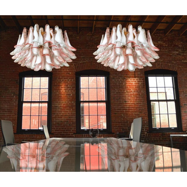 Spectacular pair of ceiling lamps with 64 pink and lattimo Murano glass. Elegant lighting object. Period: late 20th...