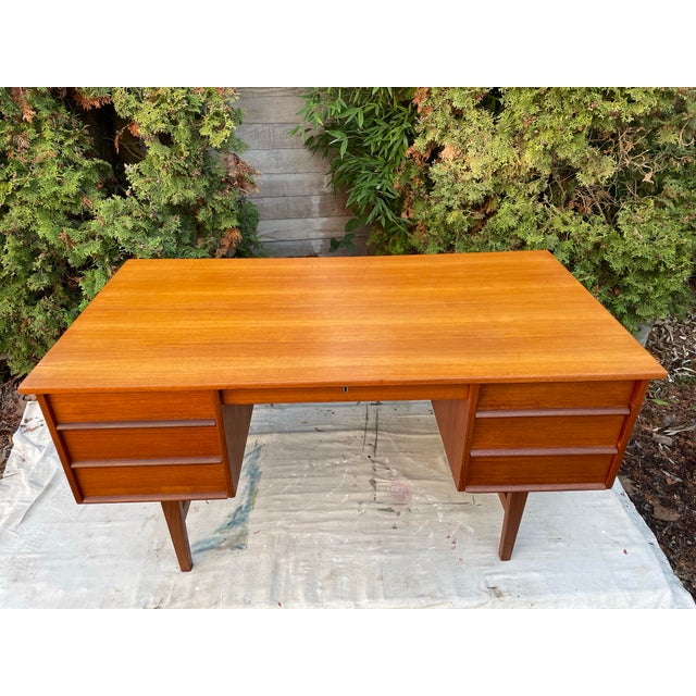 Floating atop four tapered legs that project directly below the drawer pedestals, this adorable 4 drawer writer's desk is...