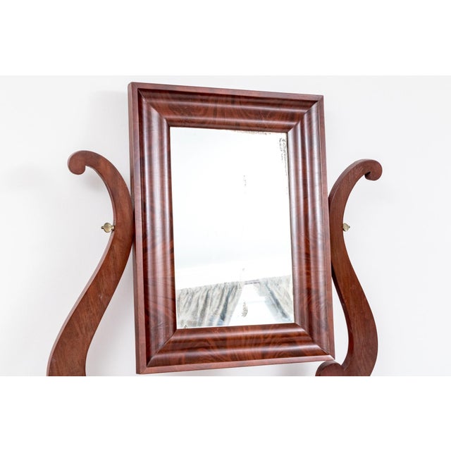 Antique American Classical Sheraton dressing table in richly figured flame mahogany, featuring an adjustable rectangular...