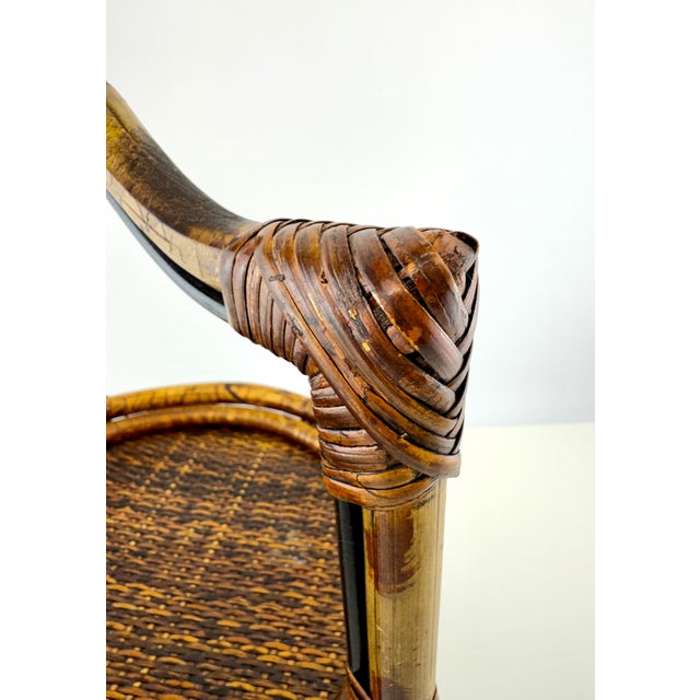 A distinctive vintage butler’s tray stand crafted of bamboo and rattan with a warm tortoiseshell-style finish. The round...