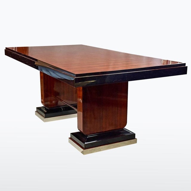 A striking and spacious dining table in the Art Deco style, featuring bold geometric forms and luxurious materials. The...