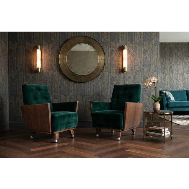 A magnificent matching pair of fully refurbished Hungarian Art Deco lounge armchairs, showcasing luxurious deep green...