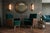 A magnificent matching pair of fully refurbished Hungarian Art Deco lounge armchairs, showcasing luxurious deep green...