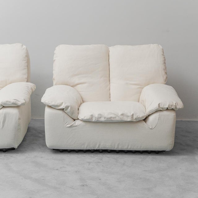 Pair of "BONHEUR" armchairs. Designed by Ammannati and Vitelli and produced by Brunati. Light fabric upholstery. Black...