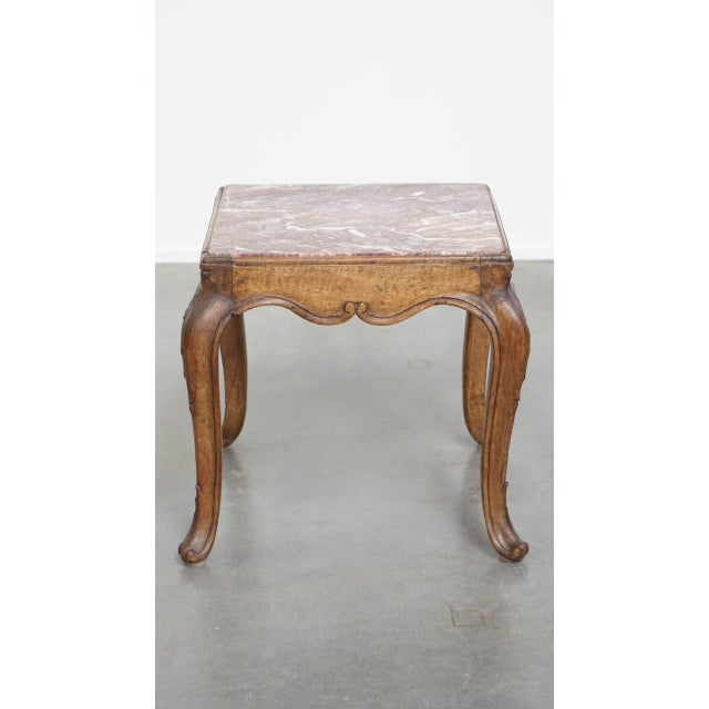 How lovely is this French square antique side table from the late 18th century? It features a wooden frame with beautiful...