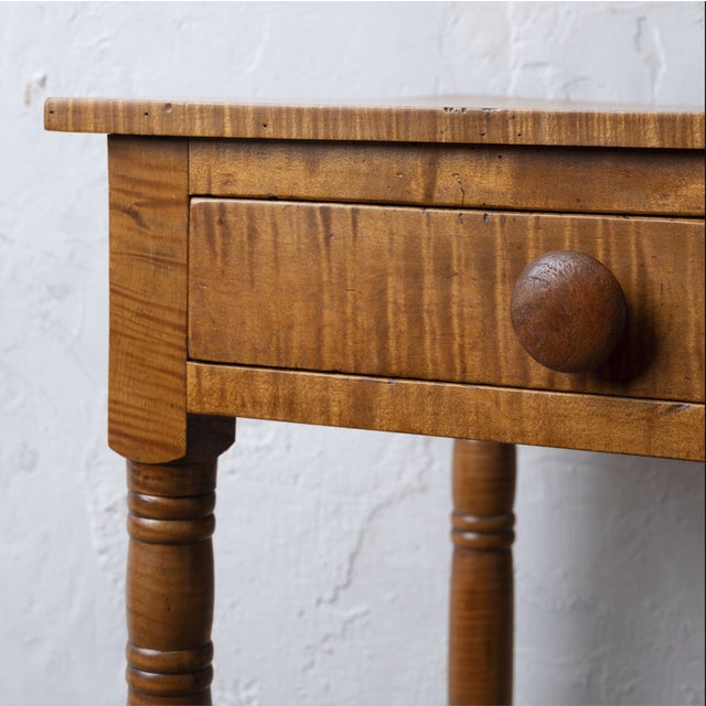 An American Sheraton curly maple one drawer stand, 19th century. 20 ⅝ inches wide by 17 ⅜ inches deep by 28 ¾ inches tall....