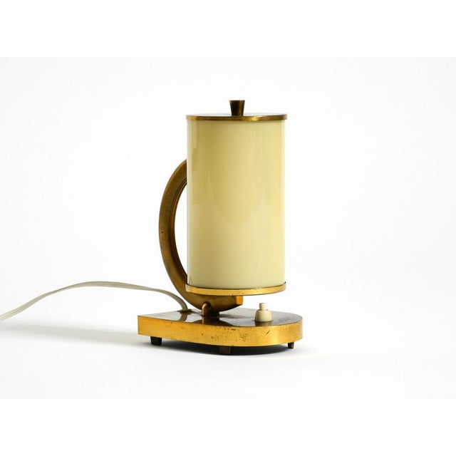 Rare brass table lamp with a beige opal glass shade from the 1940s. Great mid-century design in original condition. Made...