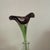 This hand-blown Murano style vase features a beautiful purple flower with a straight stem, adding a touch of elegance to...