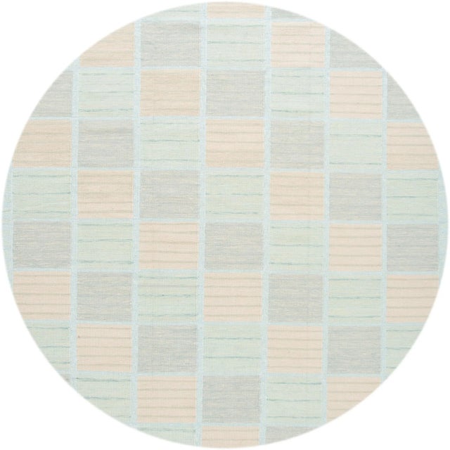 Beautiful 21st-century Swedish style rug with geometric design in a pastel-colored field. This rug measures 10'1" x 14' 1".