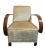 A pair of large, upholstered armchairs in the Art Deco style. The furniture features simple, geometric forms...