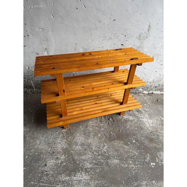 Rustic Wooden Shelving Unit This simple and functional shelving unit features a sturdy wooden frame with a natural pine...