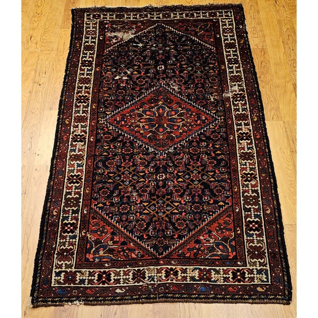 "This vintage Persian Malayer area rug from the second quarter of the 20th century features the classic Herati geometric...