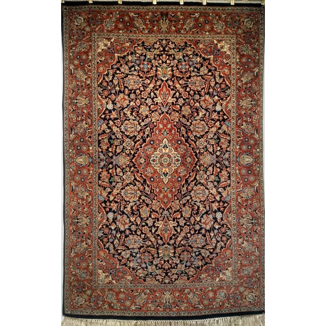 Elevate your interior with this exquisite vintage Kashan area rug, crafted in the third quarter of the 20th century....