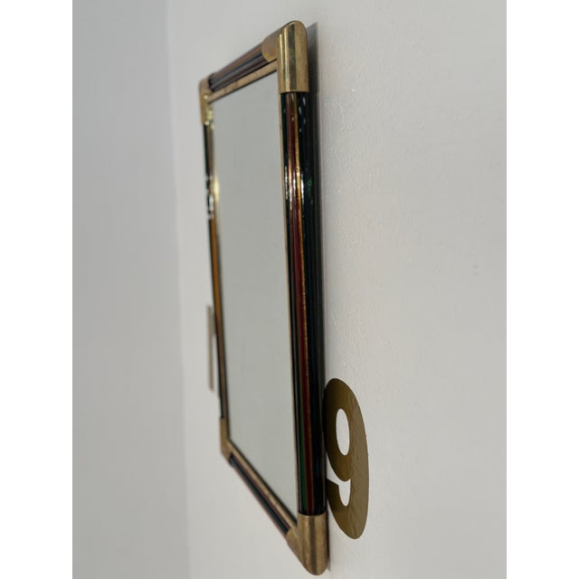 The Vintage Italian Rectangular Brass and Glass Wall Mirror from the 1980s features a distinctive design with brass...
