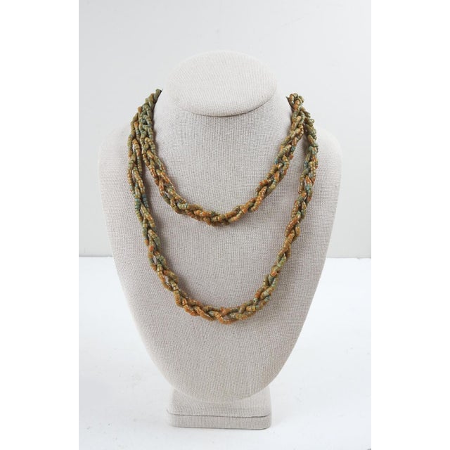 Vintage primative hand strung braided 3 strand necklace. Hand cut and dyed plastic beads, light blue base color with olive...