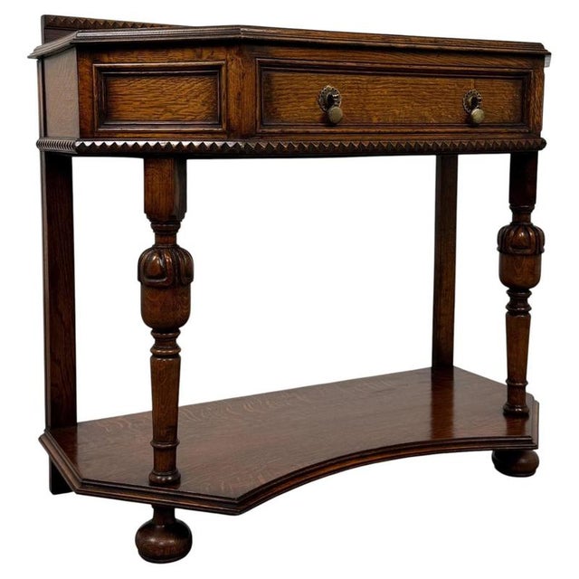 A handsome early 20th-century English side table in the Jacobean Revival style, finely crafted from oak and distinguished...