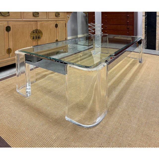 Vintage Lucite and Chrome Coffee Table in Karl Springer Style Offered for sale is a substantial vintage chrome and Lucite...