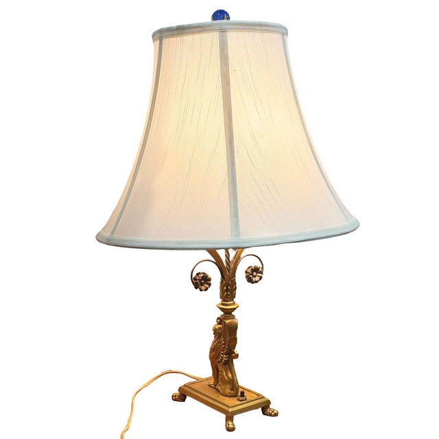 Experience the allure of classic 1930s Hollywood Regency with these exquisite cast bronze scrolling griffin table lamps....