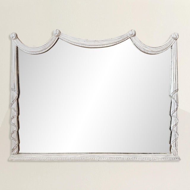 There is a deliberate sleight of hand at work here. This early 20th century faux draped overmantel mirror, likely dating...
